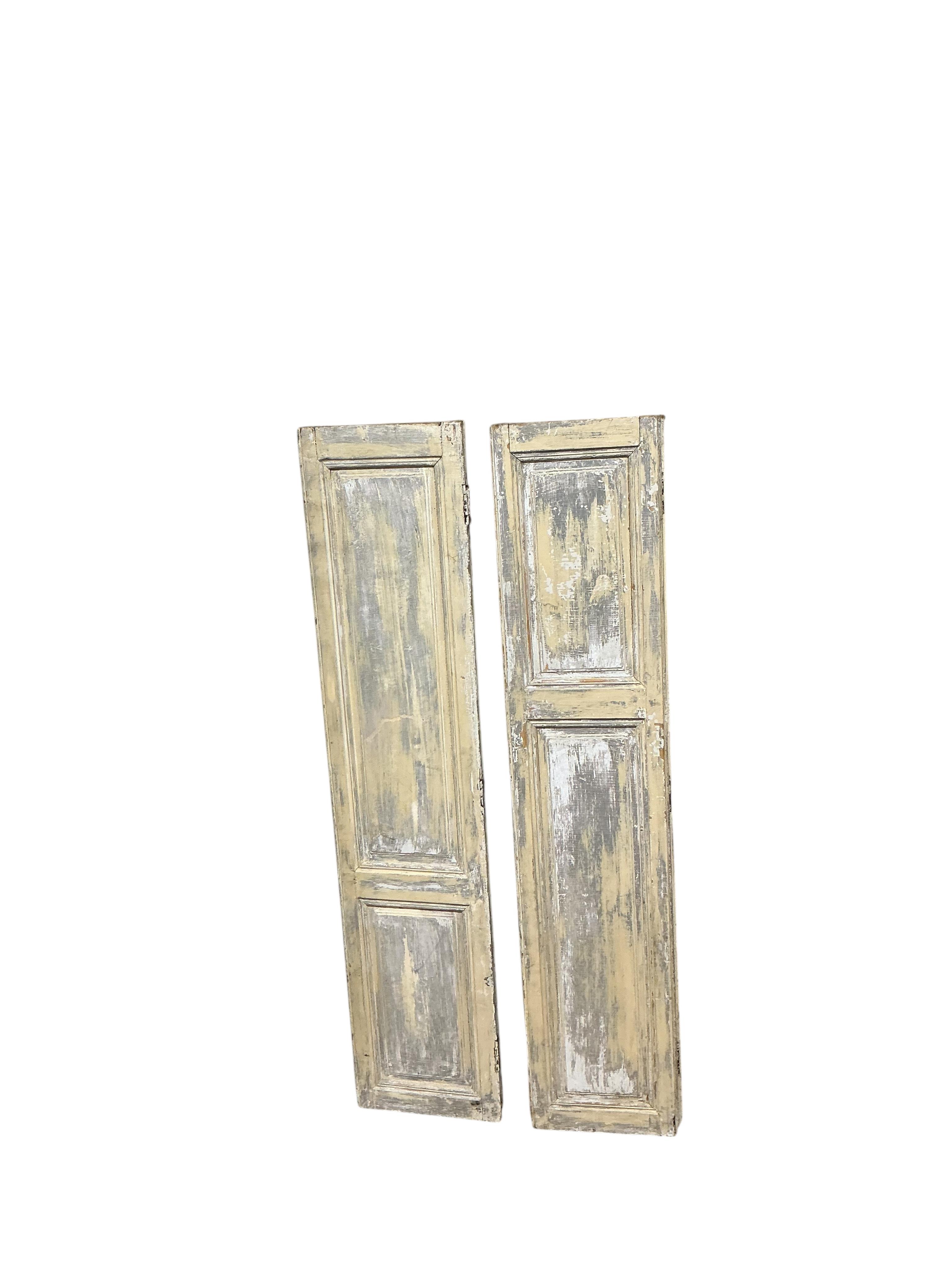 A pair of 19th century painted pine bi-fold shutters, each width 80cm, height 89cm